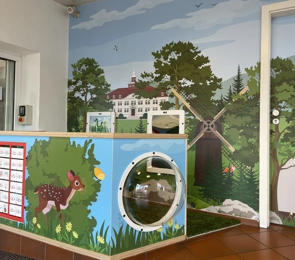 Interactive children’s play corner with farm-themed design, featuring a windmill, tunnel, and animal graphics