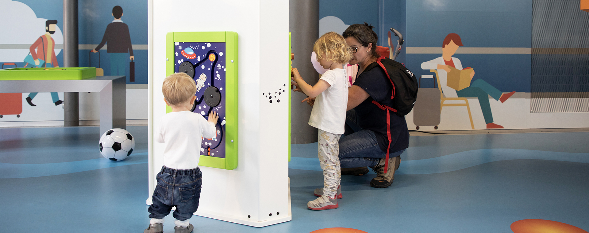 this image shows a kids corner with wall game in an airport