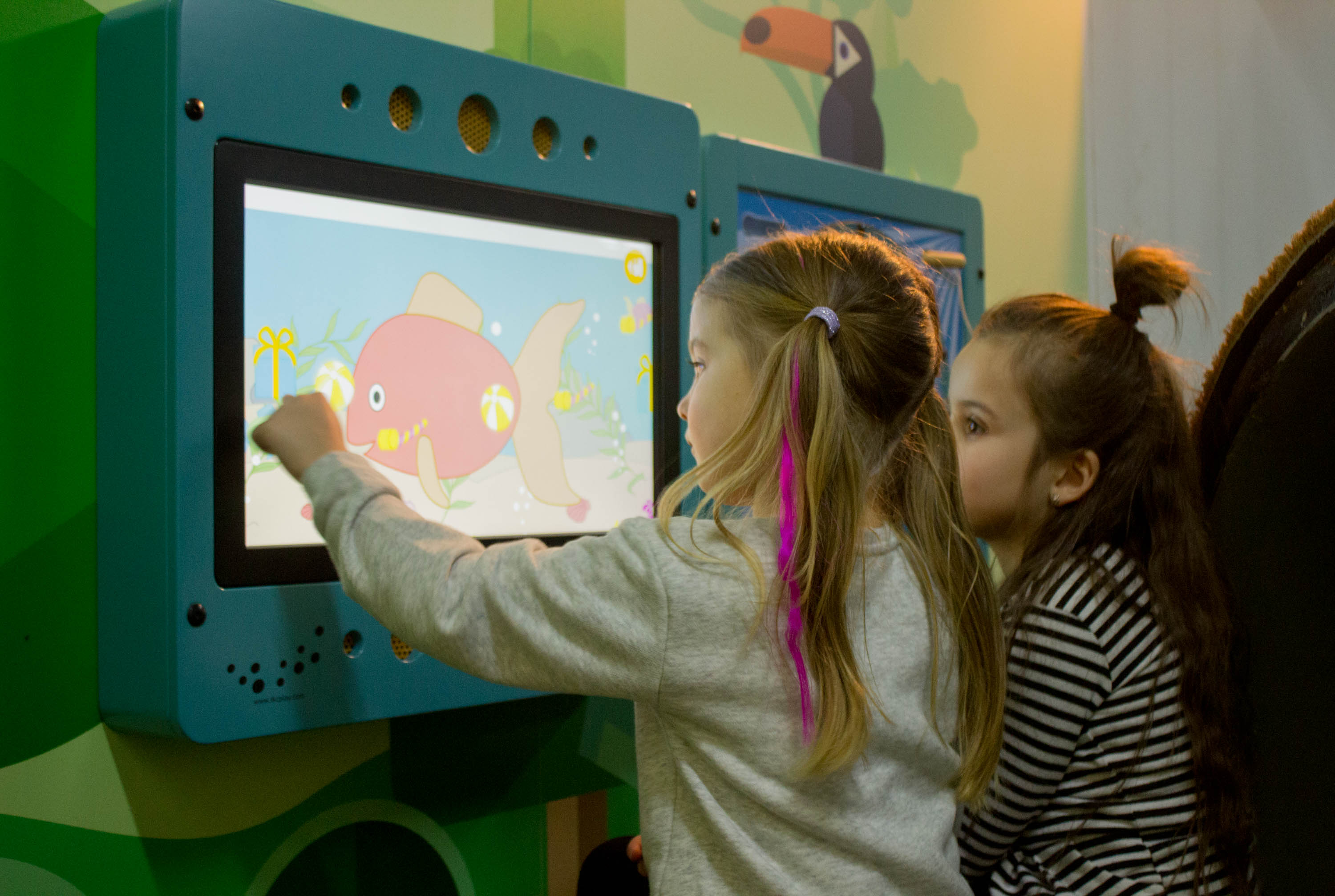 two children playing with the interactive play systems of IKC