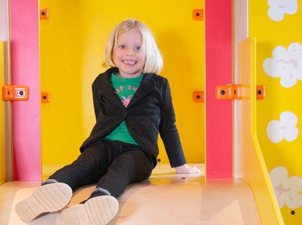 Girl on slide in play area at cinema Pathé Helmond