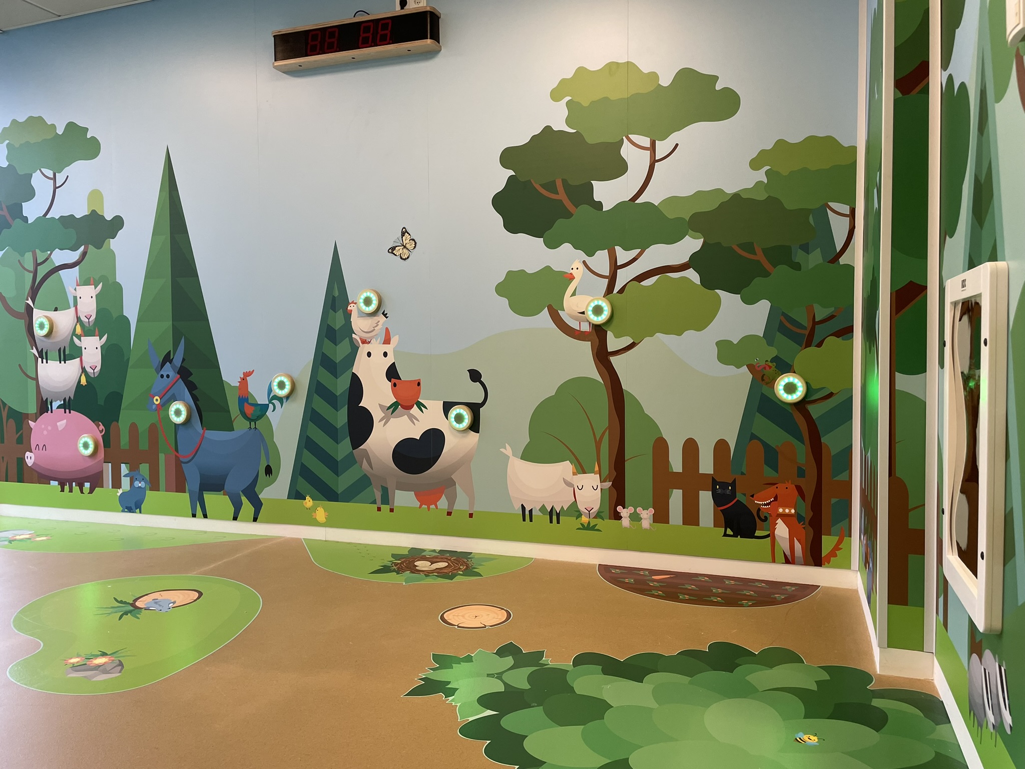 Farm-themed interactive play wall for children with sensor lights, animal illustrations and a nature-inspired EPDM floor